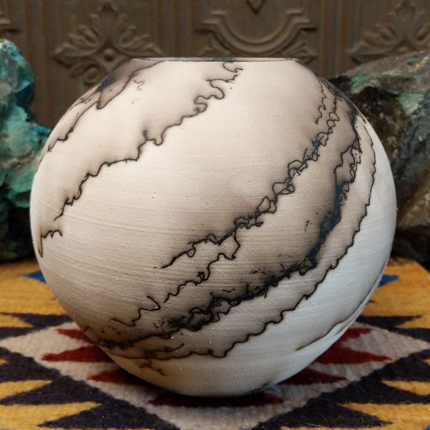 Medium globe-shaped white horsehair pottery vase by local artist Jim Calhoun featuring smoky organic patterns, a polished finish, and Southwestern handcrafted design.