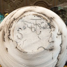Medium globe-shaped white horsehair pottery vase by local artist Jim Calhoun featuring smoky organic patterns, a polished finish, and Southwestern handcrafted design.  Underside view with artisan initials.