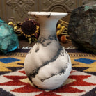 Small flared white horsehair pottery vase by local artist Jim Calhoun featuring smoky organic patterns, polished finish, and handcrafted Southwestern style.