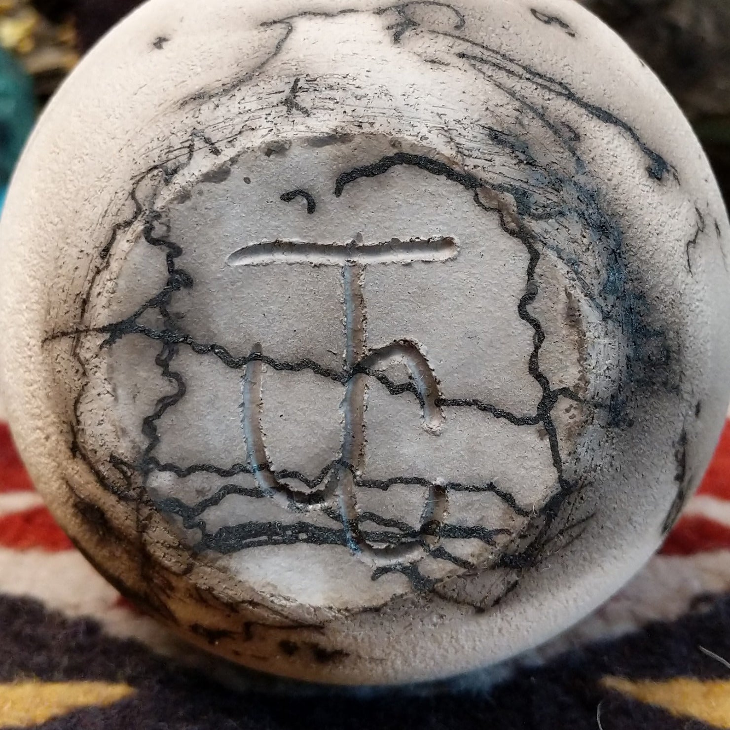 Small flared white horsehair pottery vase by local artist Jim Calhoun featuring smoky organic patterns, polished finish, and handcrafted Southwestern style.  Underside view with artisan initials.