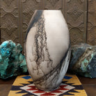 Large oval-shaped white horsehair pottery vase by local artisan Jim Calhoun featuring bold black smoky patterns, polished white finish, and handcrafted Southwestern design.