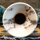Tall flared white horsehair pottery vase by local artisan Jim Calhoun featuring smoky black organic patterns, polished white finish, and handcrafted Southwestern design.  Top view.