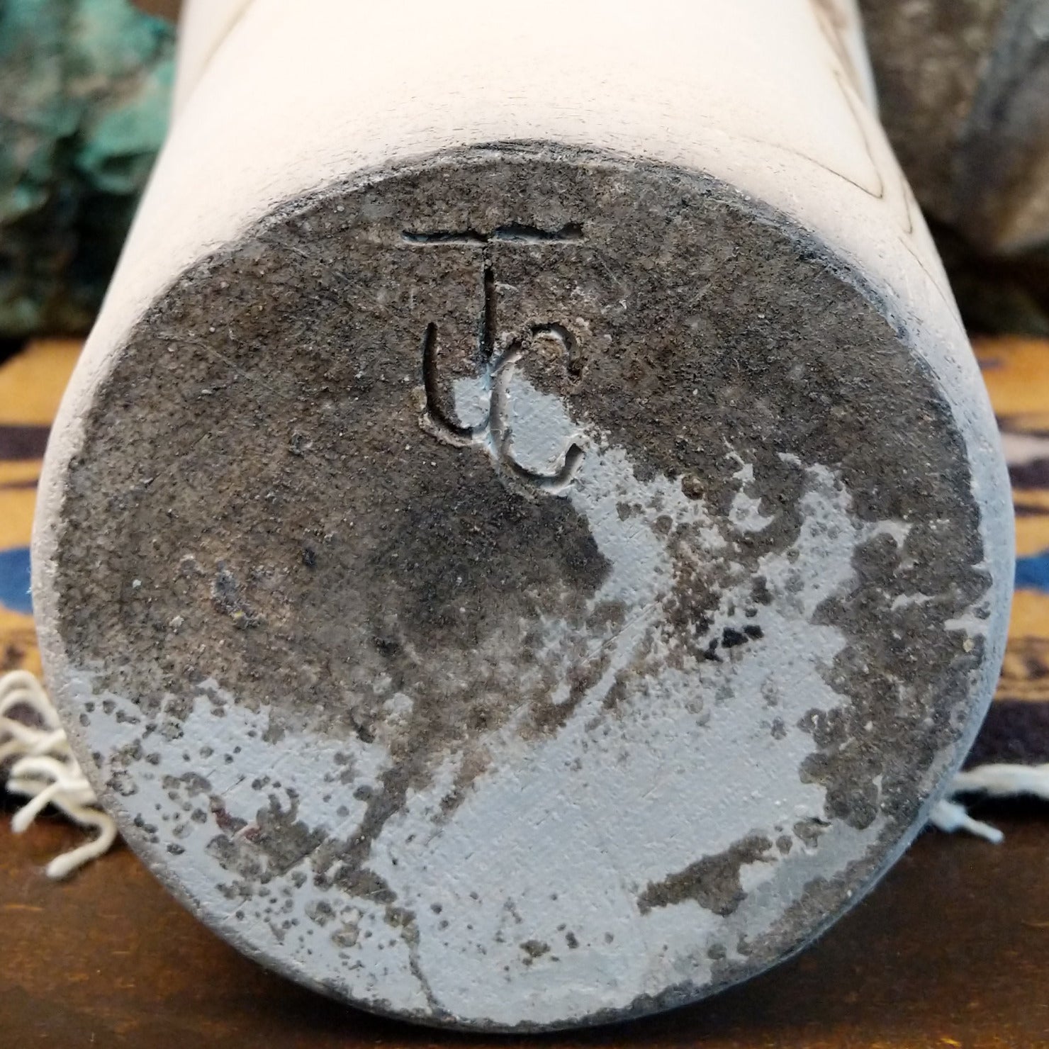 Tall flared white horsehair pottery vase by local artisan Jim Calhoun featuring smoky black organic patterns, polished white finish, and handcrafted Southwestern design.  Underside view with artisan initials.