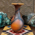 Flared terracotta horsehair vase handcrafted by local artisan Jim Calhoun, featuring a wide flared rim, earthy clay tones, and organic black horsehair fire patterns on the surface.