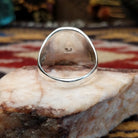 Handcrafted sterling silver multistone inlay ring by Navajo artist Bernadine Joe featuring Denim Lapis, Lapis, red and orange Spiny Oyster Shell, Mother of Pearl, Turquoise, and Malachite arranged in a colorful geometric mosaic design.  Underside view.
