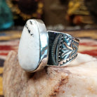 Sterling silver Navajo ovoid ring by L.P. featuring a polished White Buffalo stone set in a traditional handcrafted bezel.  Side view.