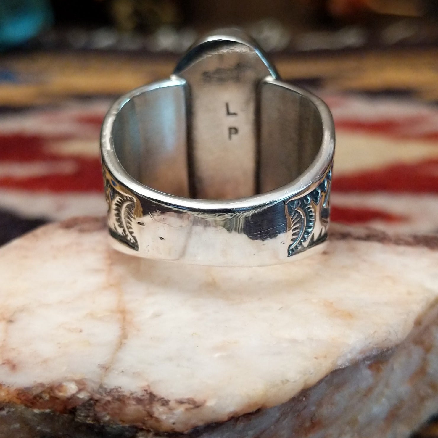 Sterling silver Navajo ovoid ring by L.P. featuring a polished White Buffalo stone set in a traditional handcrafted bezel.  Underside view.