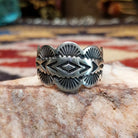 Handcrafted sterling silver scalloped ring by Elgin Tom featuring a polished finish and curved scalloped edges in a traditional Southwestern design.