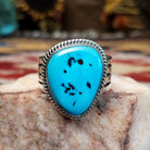 Handcrafted Navajo sterling silver ring by L.P. featuring a natural turquoise stone with traditional Southwestern silver detailing and a polished finish.