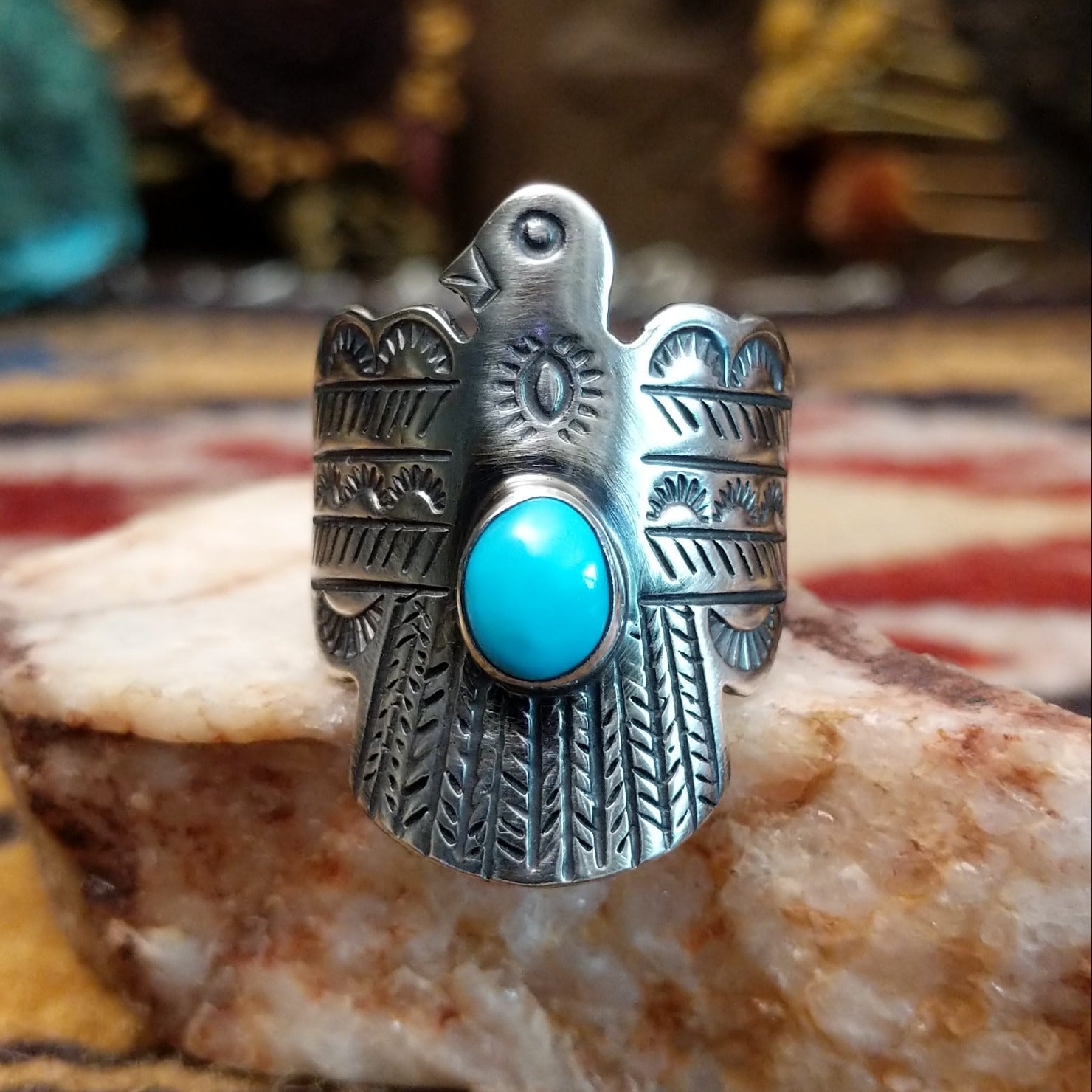 Handcrafted sterling silver Thunderbird ring by Raymond Coriz featuring a turquoise stone and traditional Southwestern Native American design details.