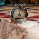 Handcrafted sterling silver Thunderbird ring by Raymond Coriz featuring a turquoise stone and traditional Southwestern Native American design details.  Underside view.