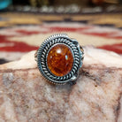 Handcrafted sterling silver ring by Artie Yellowhorse featuring a warm amber stone in a polished Southwestern Native American design.