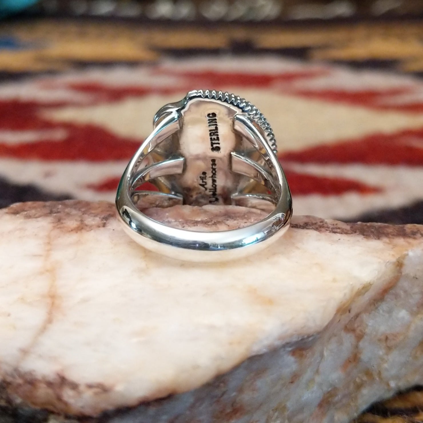 Handcrafted sterling silver ring by Artie Yellowhorse featuring a warm amber stone in a polished Southwestern Native American design.  Underside view.