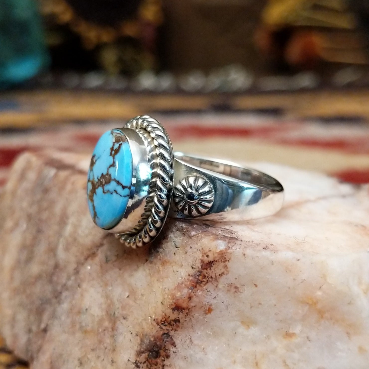Handcrafted sterling silver circle ring by Artie Yellowhorse featuring a round Golden Hills turquoise stone in a polished Southwestern Native American design.  Side view.