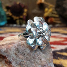 Handcrafted sterling silver dogwood flower ring by Artie Yellowhorse featuring polished floral detailing in a Southwestern Native American design.  Side view.
