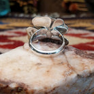 Handcrafted sterling silver dogwood flower ring by Artie Yellowhorse featuring polished floral detailing in a Southwestern Native American design.  Underside view.