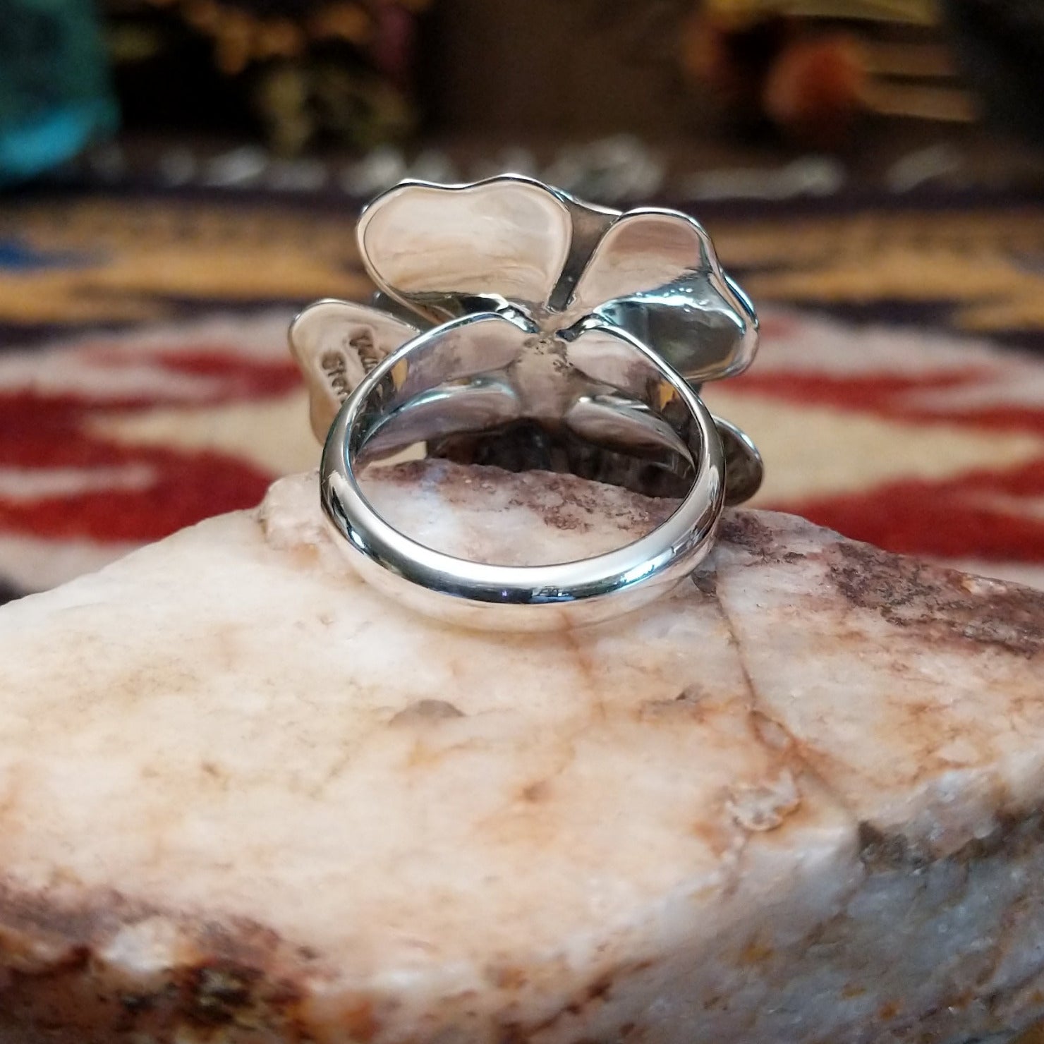 Handcrafted sterling silver dogwood flower ring by Artie Yellowhorse featuring polished floral detailing in a Southwestern Native American design.  Underside view.