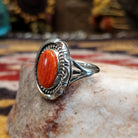 Handcrafted sterling silver oval ring by Artie Yellowhorse featuring a red spiny oyster shell in a polished Southwestern Native American design.  Side view.