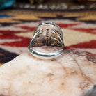 Handcrafted sterling silver oval ring by Artie Yellowhorse featuring a red spiny oyster shell in a polished Southwestern Native American design.  Underside view.