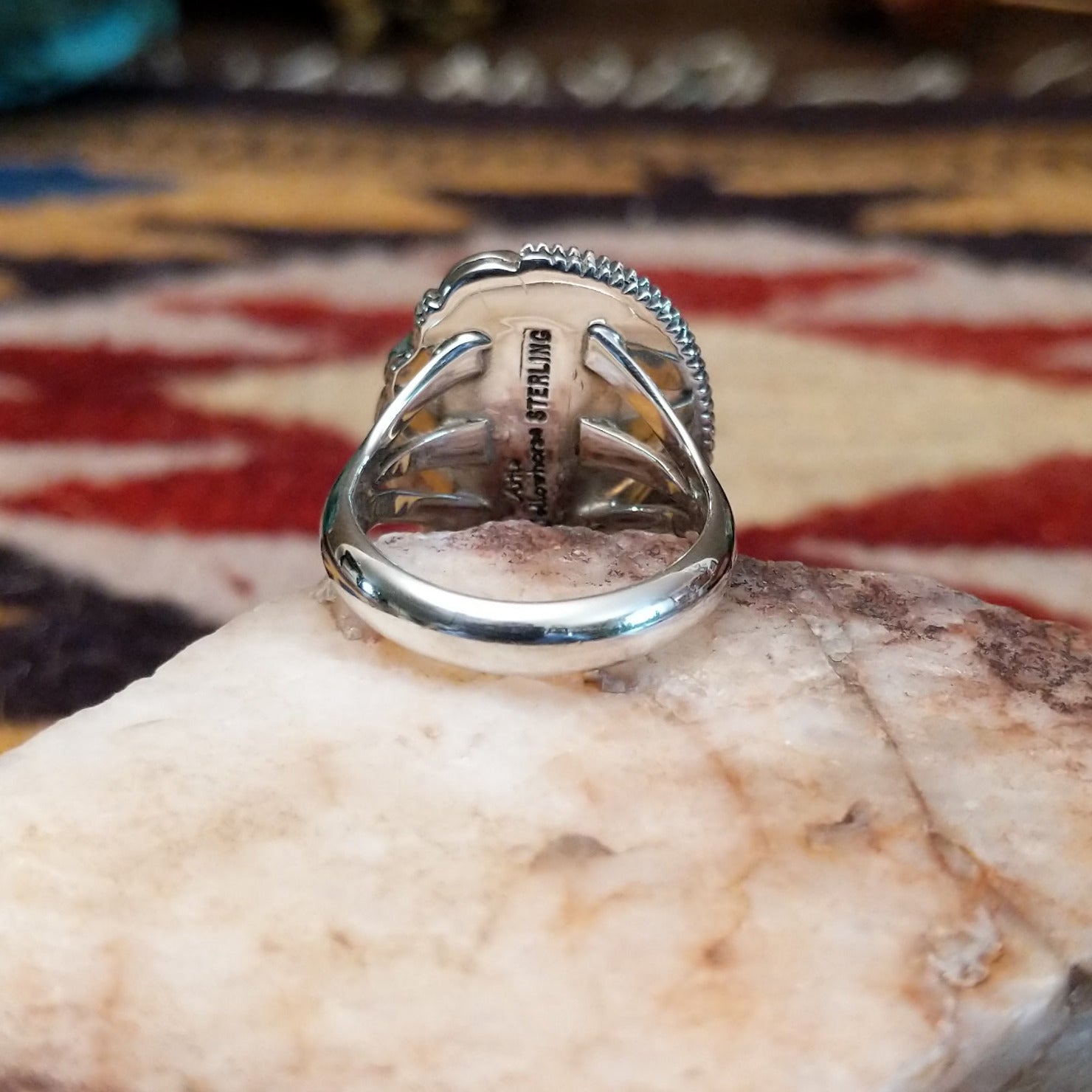 Handcrafted sterling silver oval ring by Artie Yellowhorse featuring a red spiny oyster shell in a polished Southwestern Native American design.  Underside view.