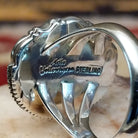 Handcrafted sterling silver oval ring by Artie Yellowhorse featuring a red spiny oyster shell in a polished Southwestern Native American design.  Artisan and Sterling Silver stamp.