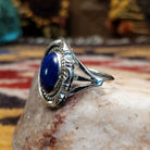 Handcrafted sterling silver oval ring by Artie Yellowhorse featuring a deep blue lapis stone in a polished Southwestern Native American design.  Side view.