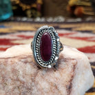 Handcrafted sterling silver ellipse ring by Artie Yellowhorse featuring a purple spiny oyster shell in a polished Southwestern Native American design.