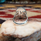 Handcrafted sterling silver ellipse ring by Artie Yellowhorse featuring a purple spiny oyster shell in a polished Southwestern Native American design.  Underside view.