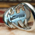 Handcrafted sterling silver ellipse ring by Artie Yellowhorse featuring a purple spiny oyster shell in a polished Southwestern Native American design.  Artisan and Sterling Silver stamp.