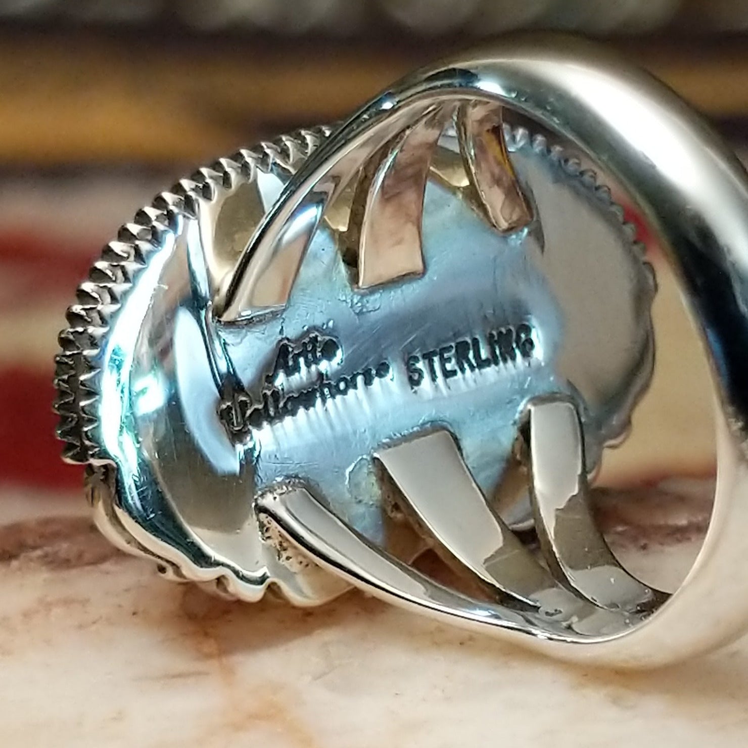 Handcrafted sterling silver ellipse ring by Artie Yellowhorse featuring a purple spiny oyster shell in a polished Southwestern Native American design.  Artisan and Sterling Silver stamp.