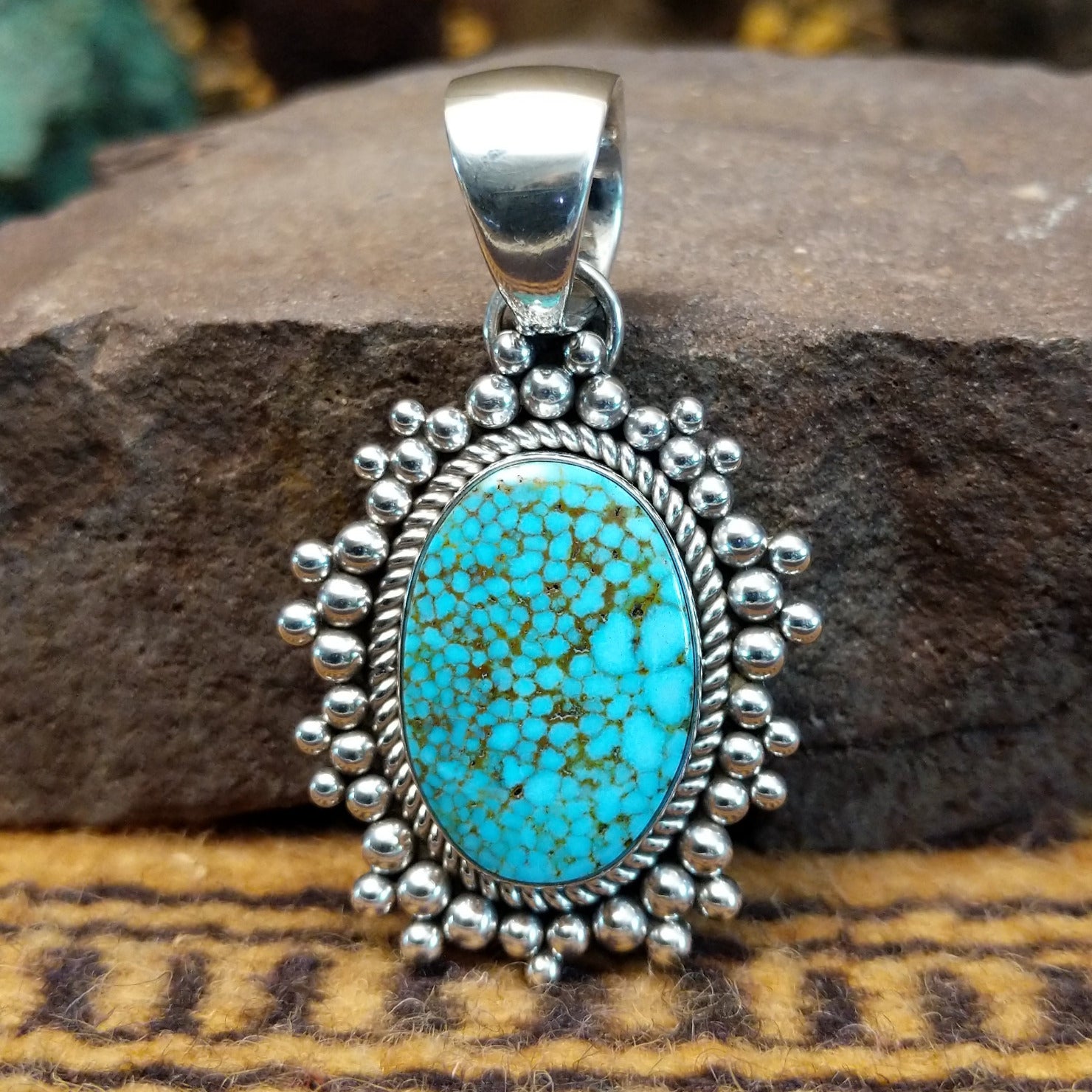 Handcrafted sterling silver pendant by Artie Yellowhorse featuring a Kingman turquoise stone in a polished Southwestern Native American design.
