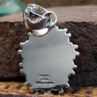Handcrafted sterling silver pendant by Artie Yellowhorse featuring a Kingman turquoise stone in a polished Southwestern Native American design.  Back view showcasing artisan and Sterling Silver stamp.