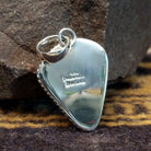 Handcrafted sterling silver pendant by Artie Yellowhorse featuring a deep purple sugilite stone in a polished Southwestern Native American design.  Back view showcasing artisan and Sterling Silver stamp.