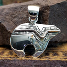 Handcrafted sterling silver pendant by Artie Yellowhorse featuring a stylized spirit bear design in a polished Southwestern Native American style.