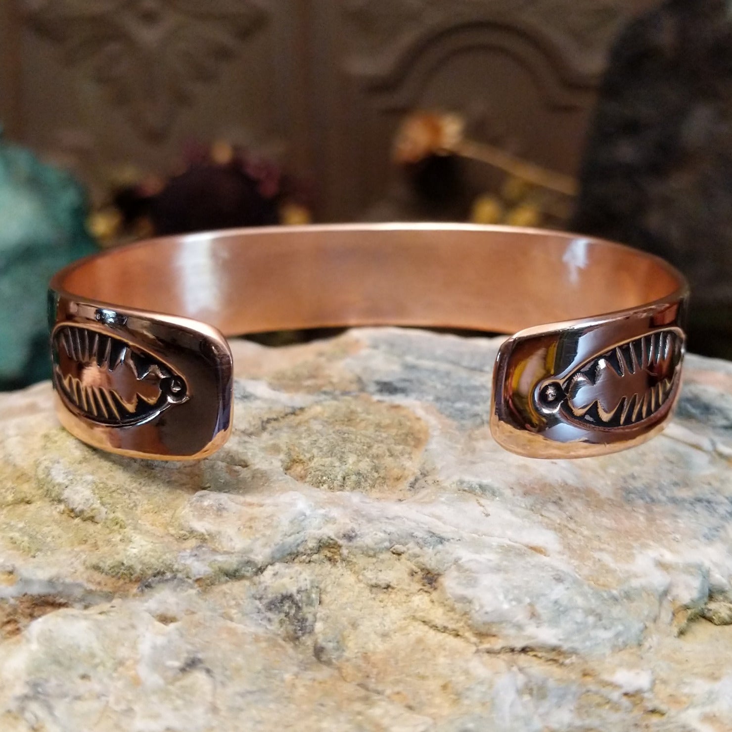 Handcrafted copper and sterling silver cuff bracelet by Robert Little featuring chevron-stamped detailing in a traditional Southwestern Native American design.  Back view.