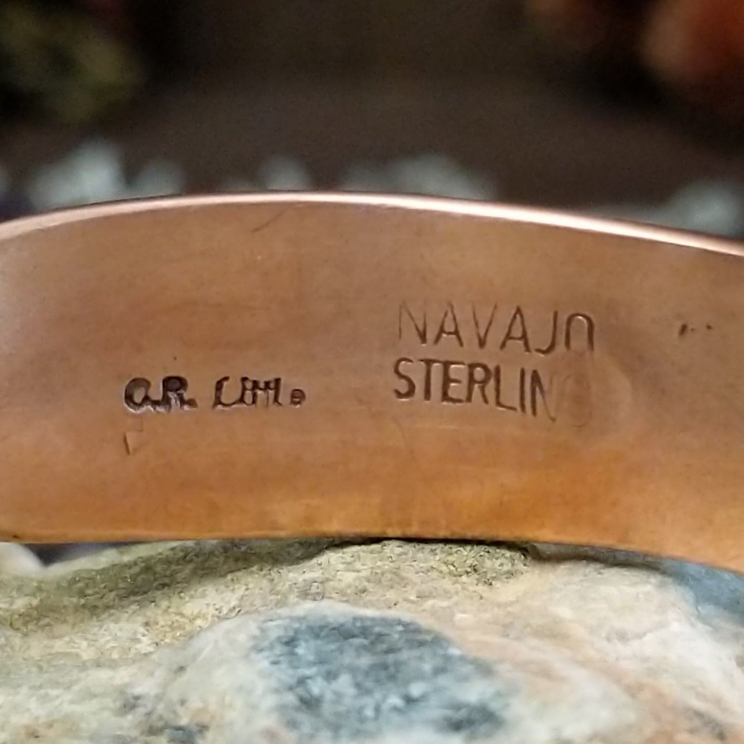 Handcrafted copper and sterling silver cuff bracelet by Robert Little featuring chevron-stamped detailing in a traditional Southwestern Native American design.  Arisan and Sterling Silver stamp.