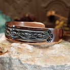 Handcrafted copper and sterling silver cuff bracelet by Navajo artisan Robert Little featuring wavy stamped detailing in a traditional Southwestern design.  Side view.
