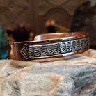 Handcrafted copper and sterling silver cuff bracelet by Navajo artisan Robert Little featuring fan-stamped detailing in a traditional Southwestern design.  Side view.