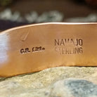 Handcrafted copper and sterling silver cuff bracelet by Navajo artisan Robert Little featuring fan-stamped detailing in a traditional Southwestern design.  Artisan and Sterling Silver stamp.