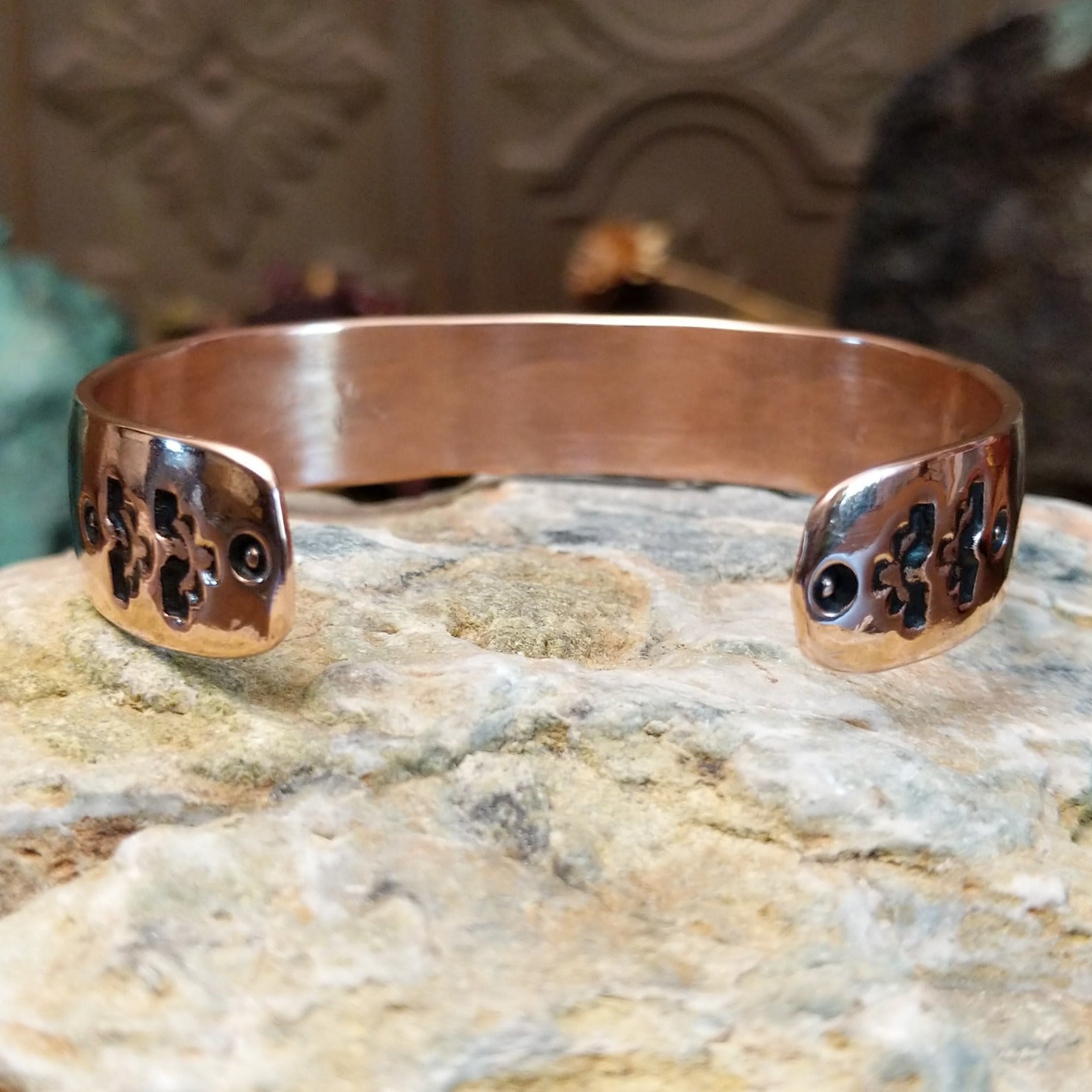 Handcrafted copper and sterling silver cuff bracelet by Navajo artisan Robert Little featuring bear paw stamped detailing in a traditional Southwestern design.  Underside view.