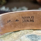 Handcrafted copper and sterling silver cuff bracelet by Navajo artisan Robert Little featuring bear paw stamped detailing in a traditional Southwestern design.  Artisan and Sterling Silver stamp.