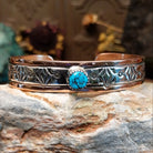 Handcrafted copper and sterling silver cuff bracelet by Navajo artisan Robert Little featuring a turquoise stone and traditional stamped detailing in a Southwestern design.