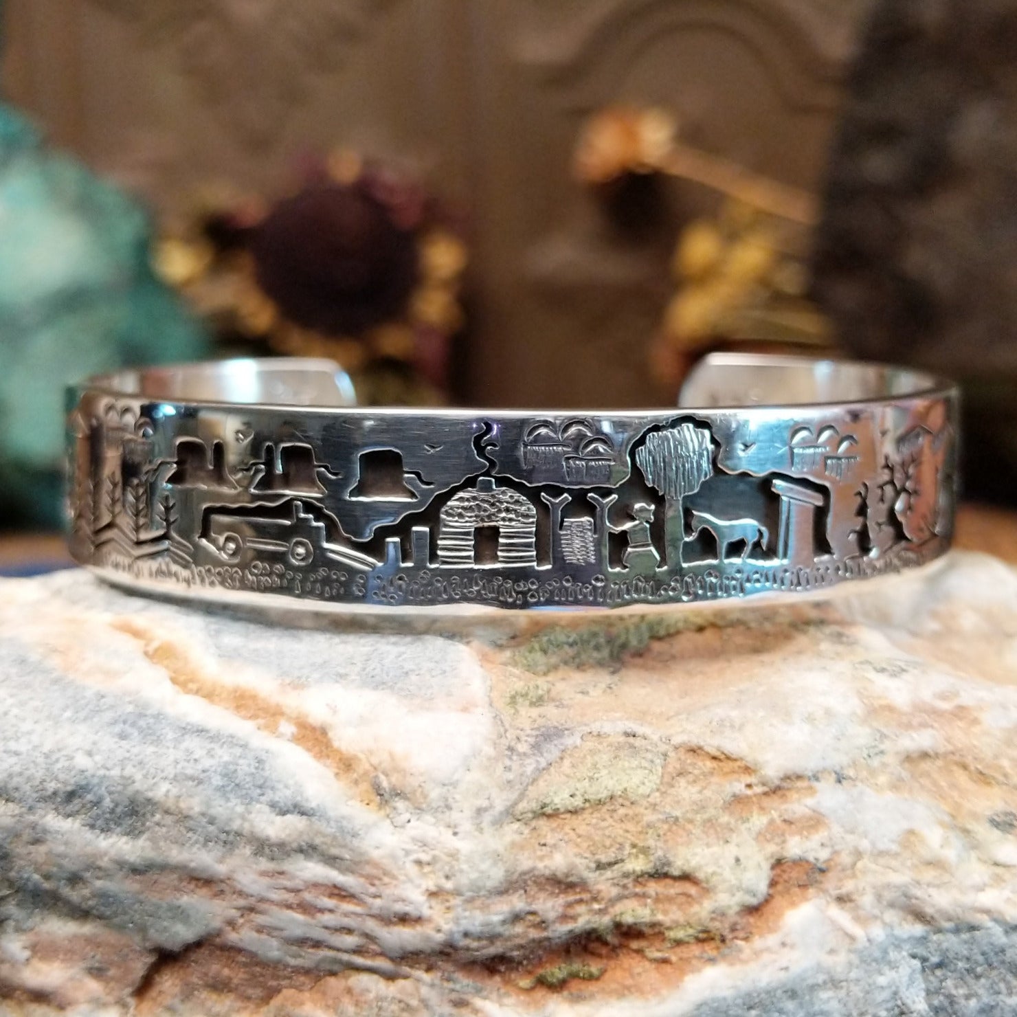 Handcrafted sterling silver cuff bracelet by Navajo artist Gilbert Begay featuring an engraved landscape storyteller design with traditional Southwestern details.