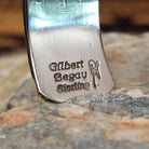 Handcrafted sterling silver cuff bracelet by Navajo artist Gilbert Begay featuring an engraved landscape storyteller design with traditional Southwestern details.  Artisan and Sterling Silver stamp.