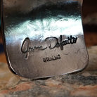 Handcrafted sterling silver cuff bracelet by Navajo artist June Delgarito featuring an engraved horse and landscape scene in a traditional Southwestern design.  Artisan and Sterling Silver stamp.