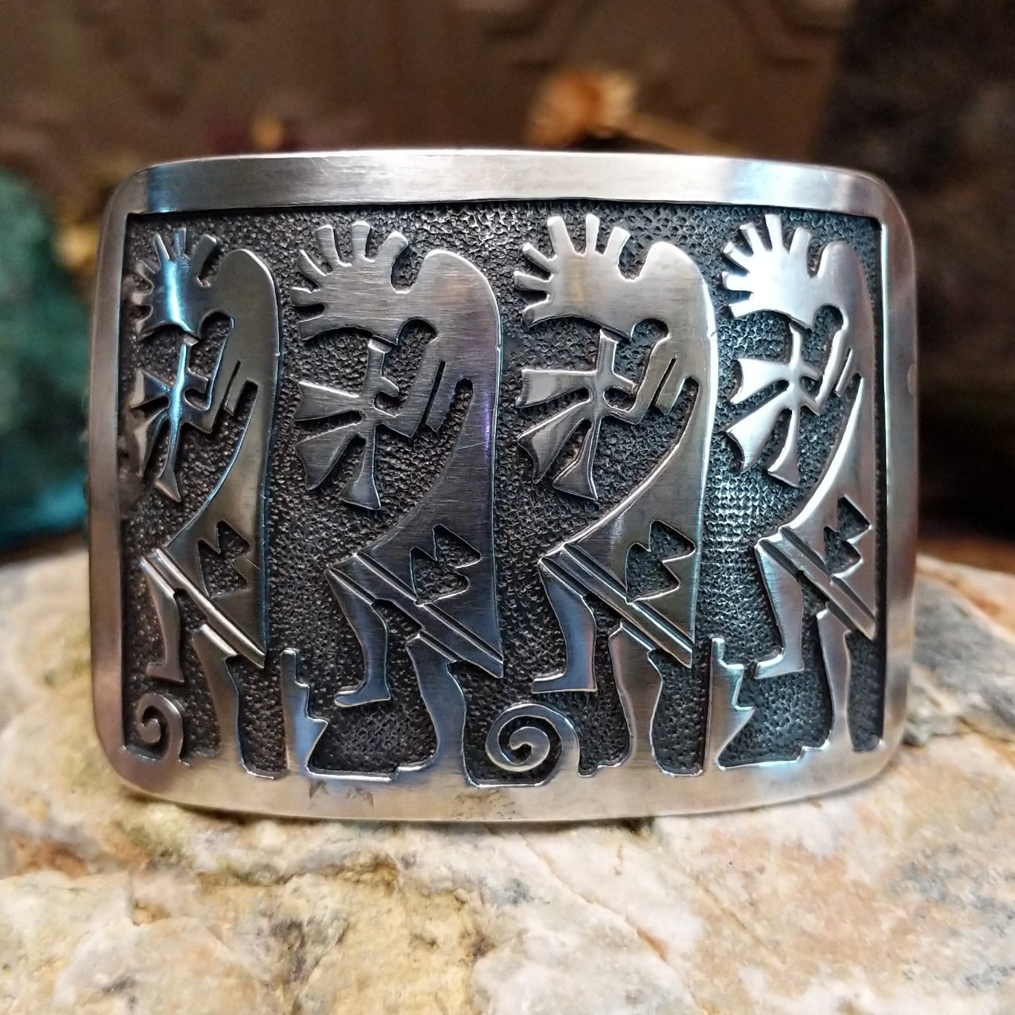 Handcrafted Navajo sterling silver cuff bracelet featuring a detailed Kokopelli design in a traditional Southwestern Native American style.