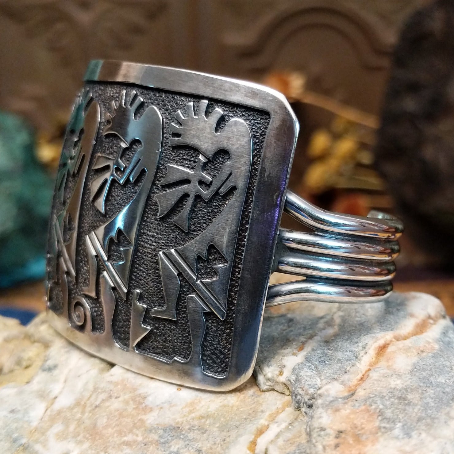 Handcrafted Navajo sterling silver cuff bracelet featuring a detailed Kokopelli design in a traditional Southwestern Native American style.  Side view.