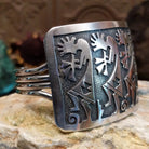 Handcrafted Navajo sterling silver cuff bracelet featuring a detailed Kokopelli design in a traditional Southwestern Native American style.  Side view.