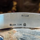 Handcrafted sterling silver cuff bracelet by Elgin Tom featuring geometric pattern detailing in a modern Southwestern Native American design.  Artisan and Sterling Silver stamp.