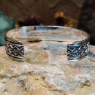 Handcrafted sterling silver cuff bracelet by Sunshine Reeves featuring diamond-stamped geometric detailing in a traditional Navajo Southwestern design.  Underside view.